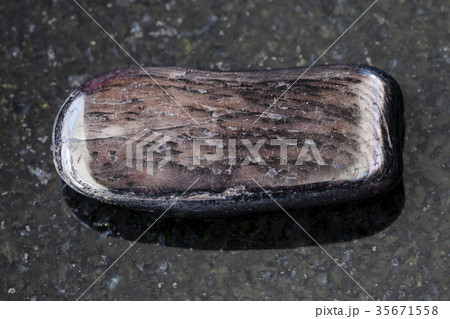 polished Hypersthene gemstone on dark background 35671558