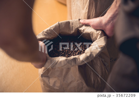 Male hands holding bag with coffee beans 35672209
