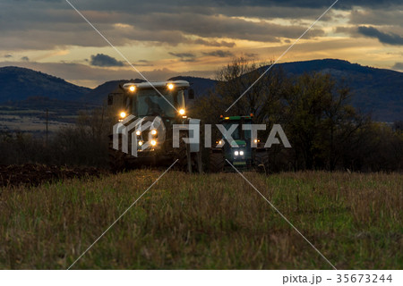 Farmer in tractor preparing land with cultivator Farmer in tractor preparing land with cultivator 35673244