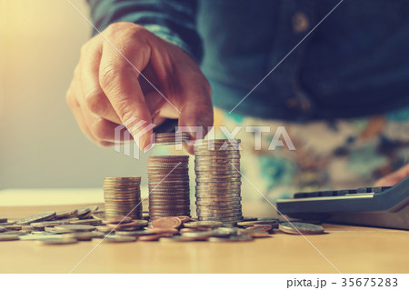 concept saving money with hand putting coins stack concept saving money with hand putting coins stack 35675283