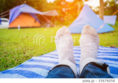 man relax on grass field when camping 35676056