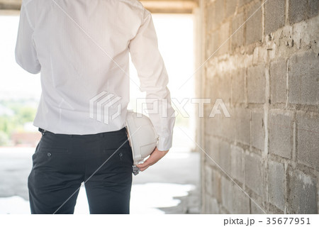 Engineer holding protective safety helmet 35677951