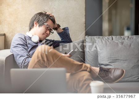 Young Asian man stress while using smartphone 35677967
