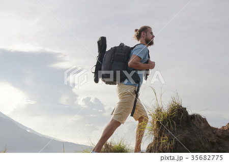 Hiker man with backpack enjoy with volcano Batur Hiker man with backpack enjoy with volcano Batur 35682775