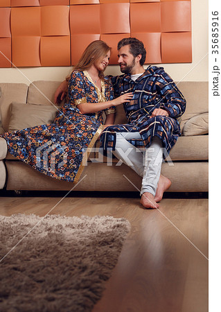 Image of woman and man in home clothes hugging on Image of woman and man in home clothes hugging on 35685916