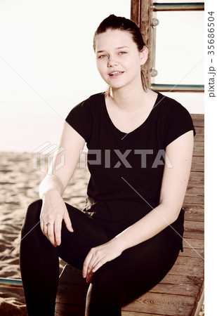 Smiling adult woman is resting after stretching Smiling adult woman is resting after stretching 35686504