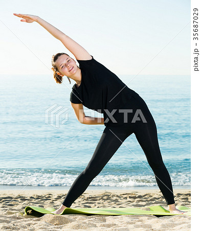 Woman 20-30 years old is practicing stretching in black T-shirt 35687029