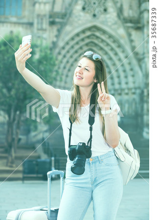 Enthusiastic female tourist making selfie 35687339