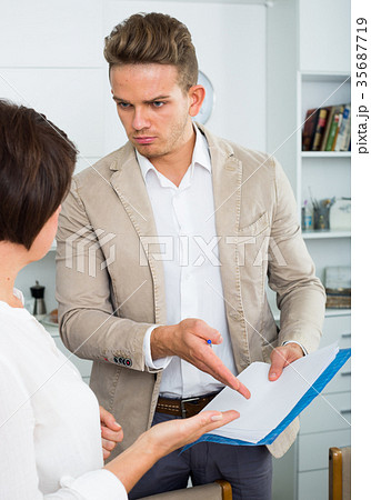 man tries woman to sign documents man tries woman to sign documents 35687719