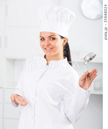 Woman cook with metal scoop 35688024