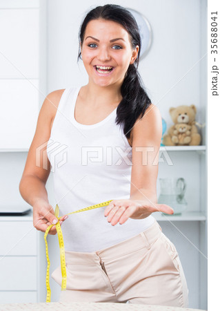 Young woman measures waist 35688041