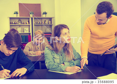 Teacher explaining difficult problem to student Teacher explaining difficult problem to student 35688095