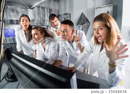 Adults laughing and grimacing in quest room-laboratory Adults laughing and grimacing in quest room-laboratory 35688638