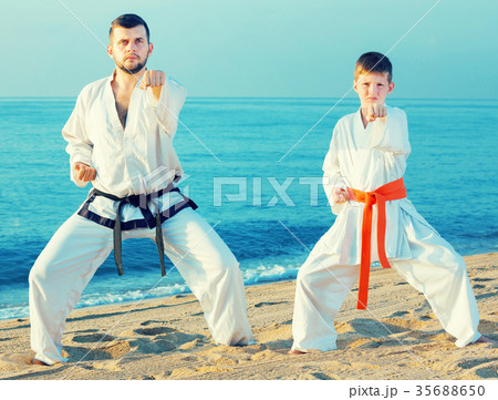 Teacher and boy doing karate poses 35688650