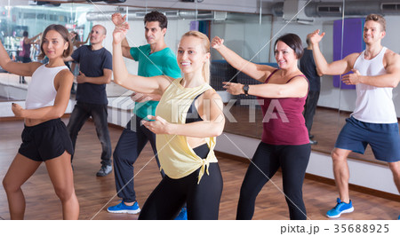 Happy beginner dancers learning zumba elements Happy beginner dancers learning zumba elements 35688925
