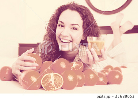 Young woman with orange juice and fruits 35689053