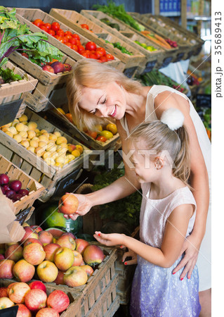 Portrait of woman and girl buying fresh fruits Portrait of woman and girl buying fresh fruits 35689413