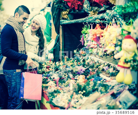 Couple buying christmas Poinsettia. Couple buying christmas Poinsettia. 35689516