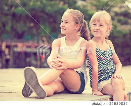Two small sisters looking into distance Two small sisters looking into distance 35689882