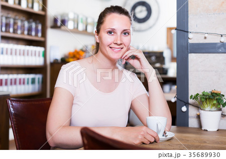 young woman resting alone in cafe and drinking coffee 35689930