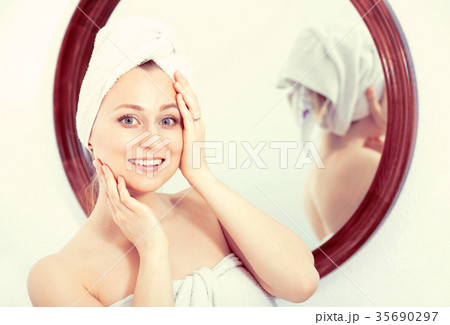 Woman after a shower near mirror Woman after a shower near mirror 35690297