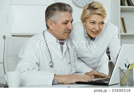 Doctor and nurse reading information 35690316