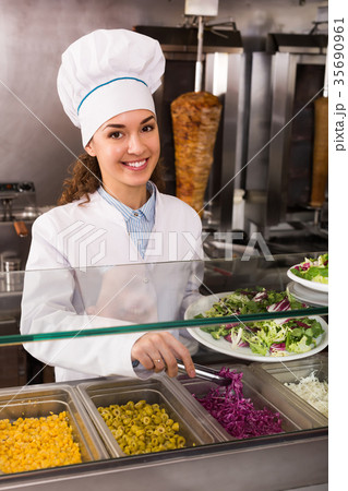 Female cook at bistro. Female cook at bistro. 35690961