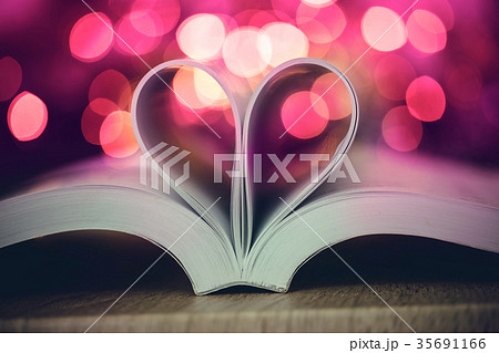 Book page  heart shape with celebration bokeh lig 35691166