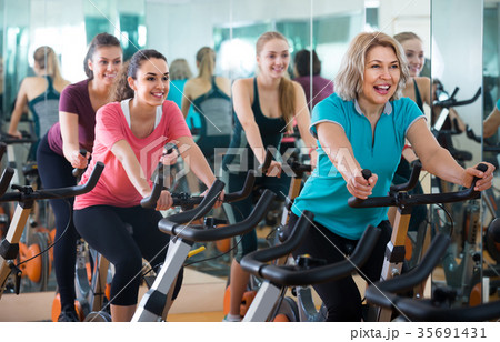 Elderly and young women working out hard in sport club 35691431
