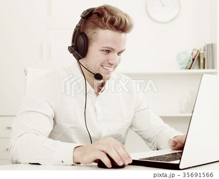 Young man working in call centre Young man working in call centre 35691566