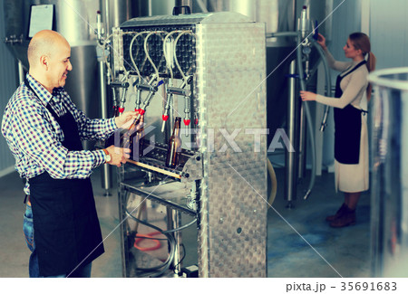 Man working on modern brewery. Man working on modern brewery. 35691683