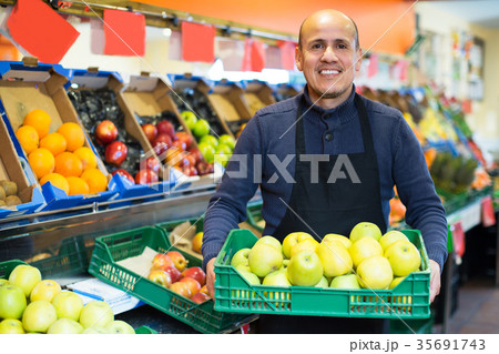 Salesman working in fruit section Salesman working in fruit section 35691743