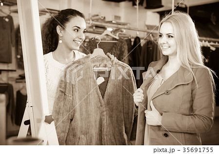 Two girls at clothing store . 35691755