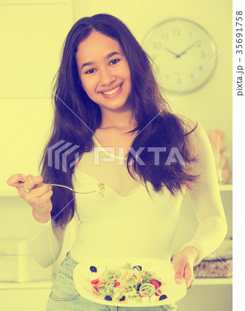 Cheerful young woman have lunch at home Cheerful young woman have lunch at home 35691758