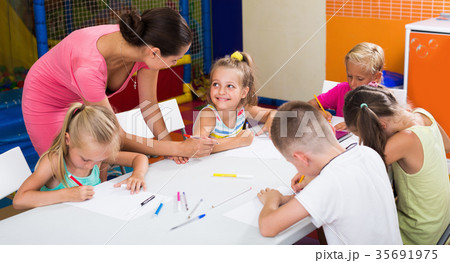 Smiling children drawing pencils on lesson in school 35691975