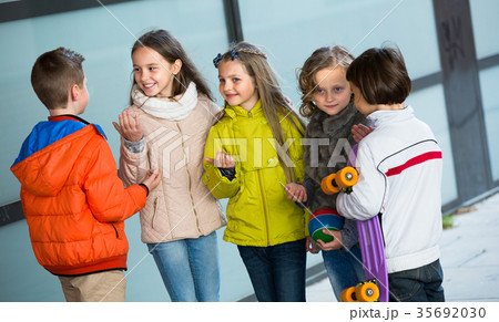 children chatting outdoors children chatting outdoors 35692030