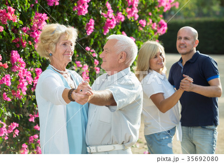 Two generation dancing in park 35692080