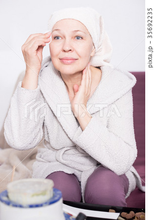 Woman cleaning face 35692235