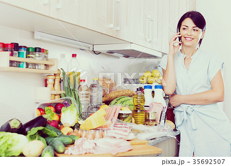 Female is chatting with husband after shopping in the market grocery indoor. Female is chatting with husband after shopping in the market grocery indoor. 35692507
