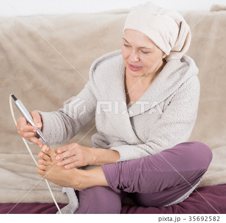 Woman doing pedicure Woman doing pedicure 35692582