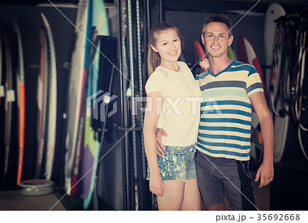 Portrait of glad couple buying surfboard Portrait of glad couple buying surfboard 35692668