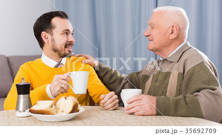 Elderly father and son breakfast Elderly father and son breakfast 35692709