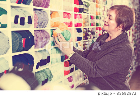 Buyer is buying colorful yarn for their hobby 35692872