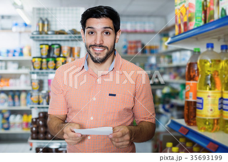 Adult man customer with note in supermarket 35693199