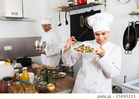 Positive female cook holding plate Positive female cook holding plate 35693233