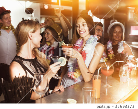 Women drinking cocktails in nightclub Women drinking cocktails in nightclub 35693373