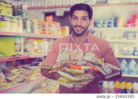 Portrait of adult male standing with purchases Portrait of adult male standing with purchases 35693385