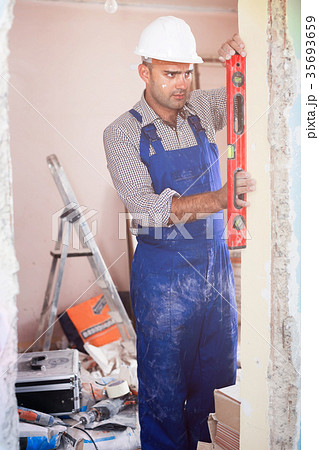 Professional builder measuring doorway Professional builder measuring doorway 35693659