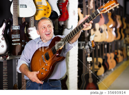 Man choosing electric guitar 35693914