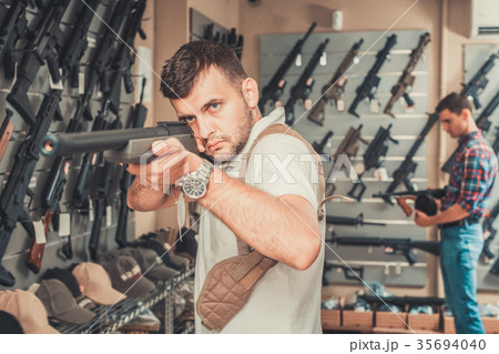 Men choosing air weapon Men choosing air weapon 35694040